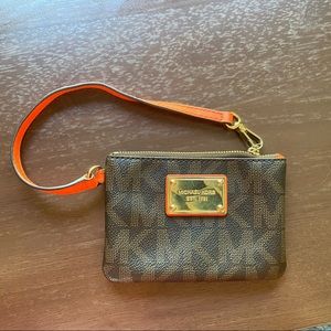 Micheal Kors coin purse wristlet with orange accents